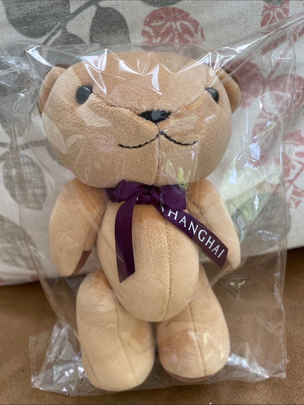 Plush Beige Teddy Bear with Purple Ribbon - Accent